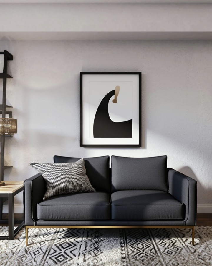 The same living room after Roomframe AI magic edit, with the sofa recolored dark gray under new wall art