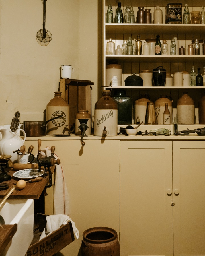 Cluttered old kitchen with beige cabinets before AI redesign