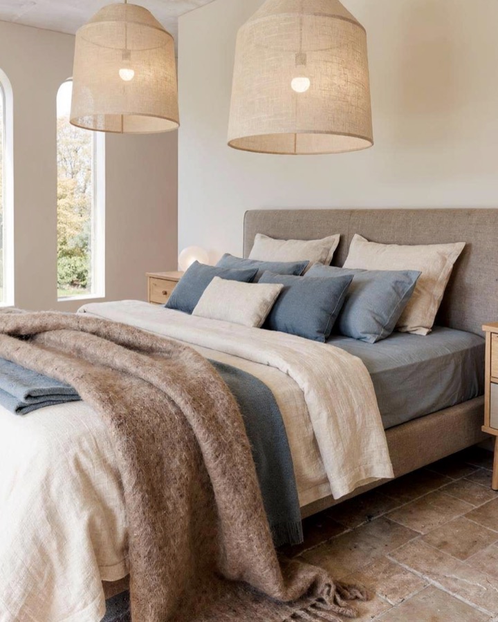 The bedroom restyled by Roomframe AI from an inspiration photo, with woven pendant lamps and blue and beige textiles